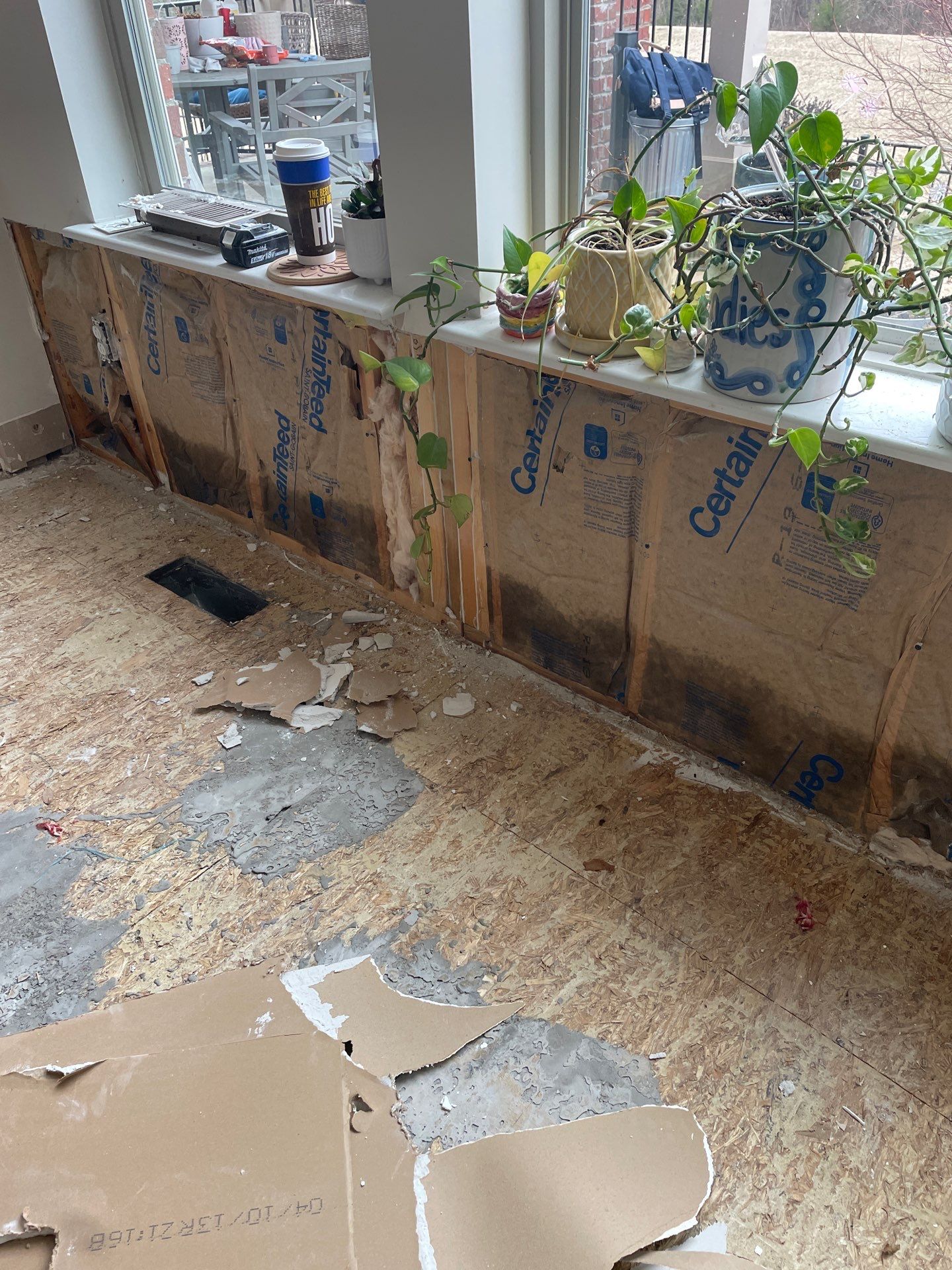 Damaged wall insulation and subfloor after storm damage in Chicago